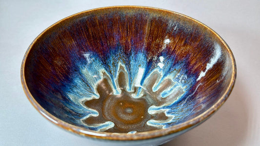 Royal Cascades ceramic bowl interior with blue-and-brown reactive glaze, speckled design