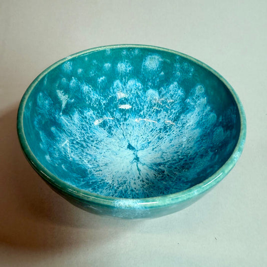 Small turquoise ceramic surf bowl with glossy speckled glaze, wide round opening