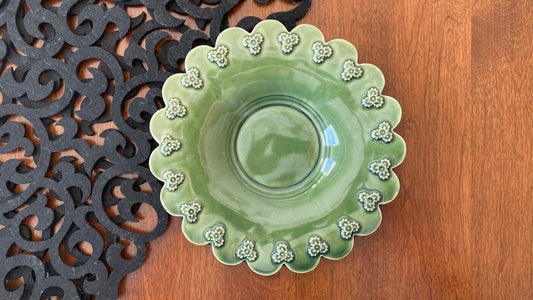 Light green scallop-edged plate with white flower trim and central shallow dish