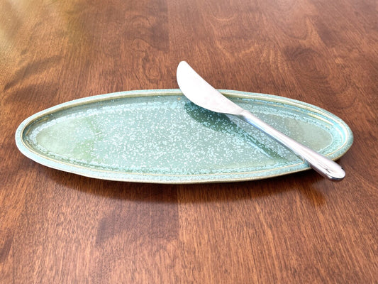 Small oval stoneware serving dish, ivy green speckled glaze with shiny crystal accents
