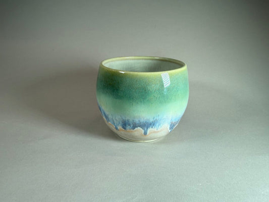 Ceramic bowl with blue-green gradient and glossy finish