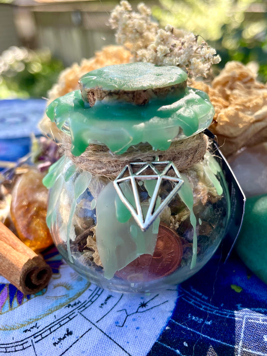 Green spell jar with cork lid and pentagram charm on glass