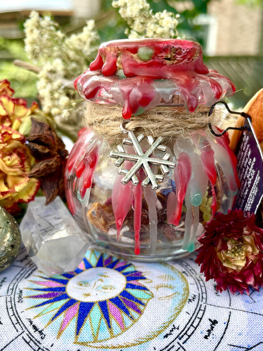 Decorative spell jar with clear glass, red wax seal, twine wrap, snowflake charm