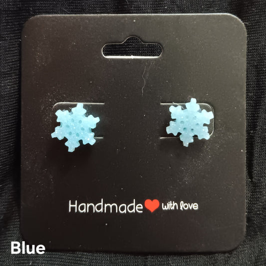 Blue snowflake stud earrings with textured, sparkly finish
