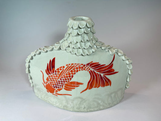 Ceramic koi vase with mint-green ridged lid and red swimming fish design